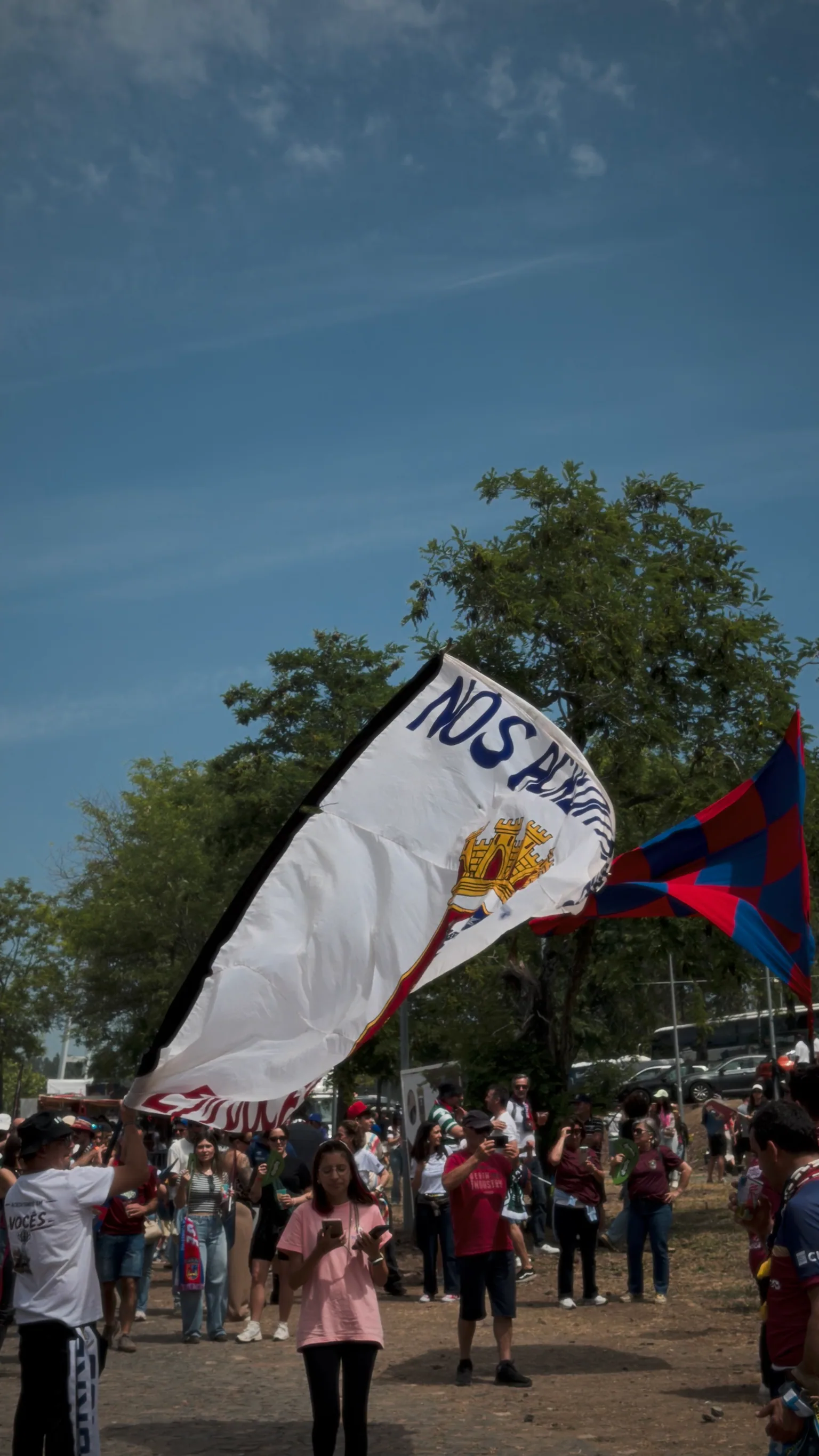 A large Torreense supporters' flag being waved above the crowd before kickoff at Jamor
